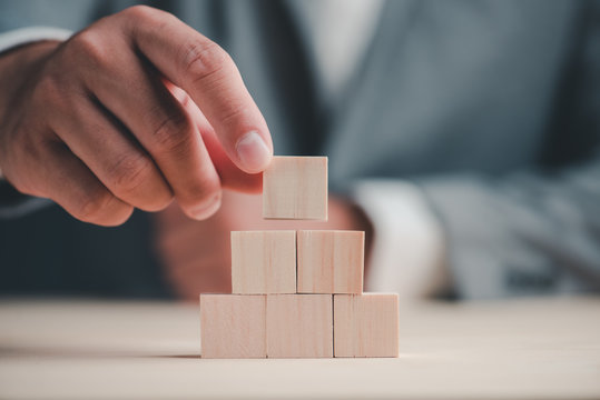 hand stack woods block step on table. business development concept.copy space.