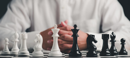 Businessman play with chess game. concept of business strategy and tactic.strategy, management or leadership concept