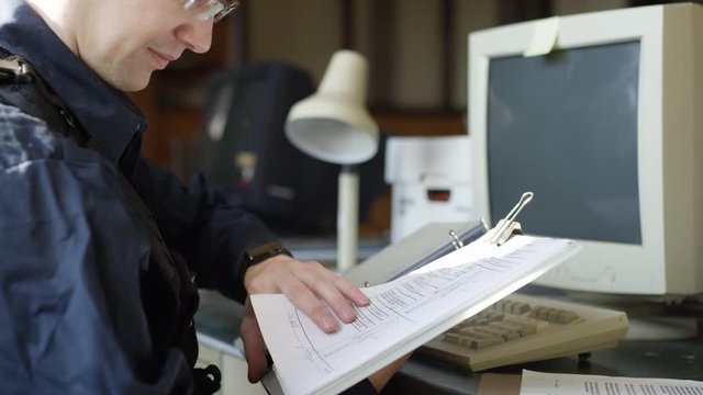 Police officer in precinct solving crimes