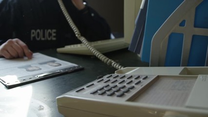 Police officer in precinct solving crimes