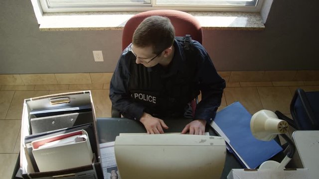 Police officer in precinct solving crimes
