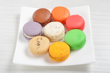 Colorful french macarons on white plate