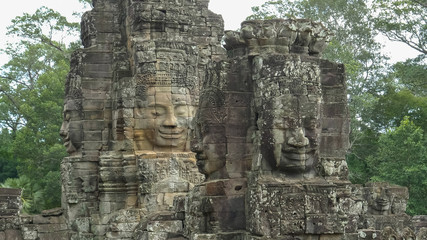 Fototapeta na wymiar four large carved stone faces at bayon temple