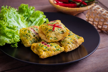 Fried minced pork, prawns, vegetable and nut wrapped in egg net (Latieng), Thai traditional food