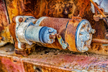 Close-up view of rusted starter on an abandoned tractor