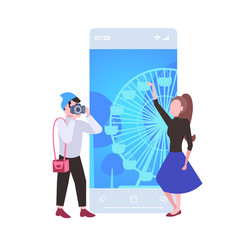 happy tourists couple traveling together man holding camera to shoot his girlfriend travel concept ferris wheel background smartphone screen mobile app flat full length