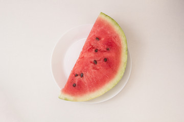 Fototapeta na wymiar Slice of watermelon on a white plate
