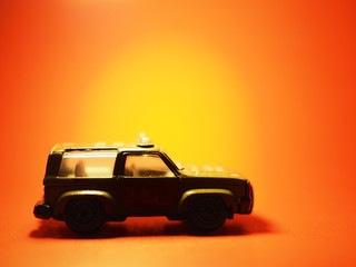 Military vehicles model parked on a red background and the light from fire