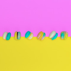 Mini Macaroons on colored background.  Stylish food art