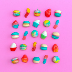 Fototapeta premium Macaroons and sweet mix on pink background. Stylish flat lay food art