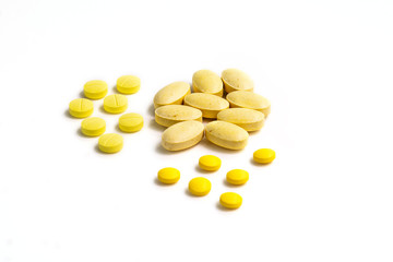 Close up assorted medical drugs, antibiotic pharmaceutical medicine pills and syringe isolated on white background. Yellow tablets pills with copy space. Medicine and healthy concept.