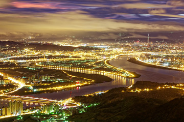 Aerial panorama over Taipei, the capital City of Taiwan, on a blue gloomy evening with view of the...