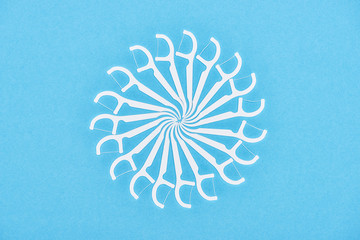top view of white floss toothpicks isolated on blue