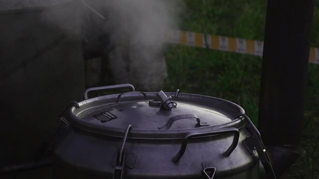 Boiling water at field army pan. Steam rising to clear night air.