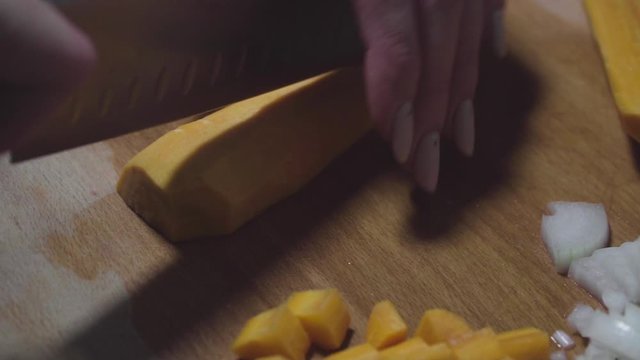Women's hands wash, peel and cut vegetables into vegetable stew.