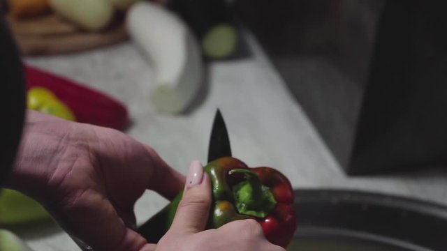 Women's hands wash, peel and cut vegetables into vegetable stew.