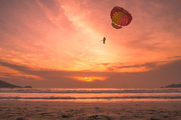 Sunset lovers, bright orange sky, on the beach Famous Phuket Patong Thailand