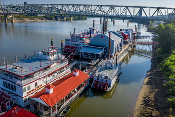 Blue red white steamboats docked on the Ohio river between Newport and Cincinnati