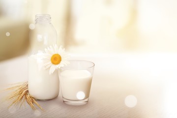 Obraz na płótnie Canvas Glass of milk and bottle on background