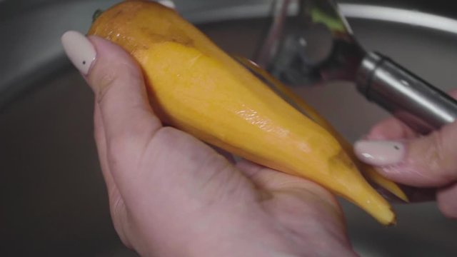 Women's hands wash, peel and cut vegetables into vegetable stew.