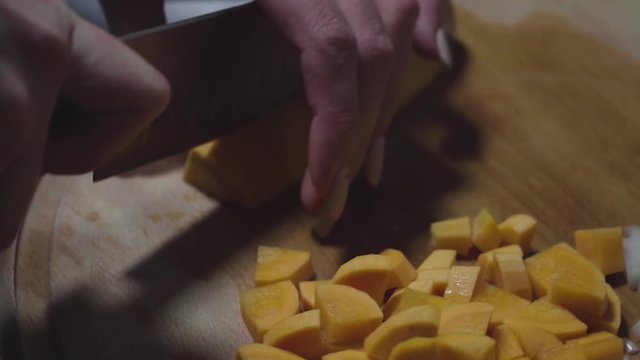 Women's hands wash, peel and cut vegetables into vegetable stew.