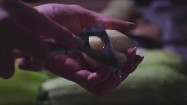Women's hands wash, peel and cut vegetables into vegetable stew.
