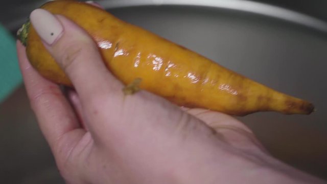 Women's hands wash, peel and cut vegetables into vegetable stew.