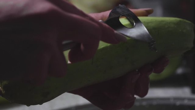 Women's hands wash, peel and cut vegetables into vegetable stew.