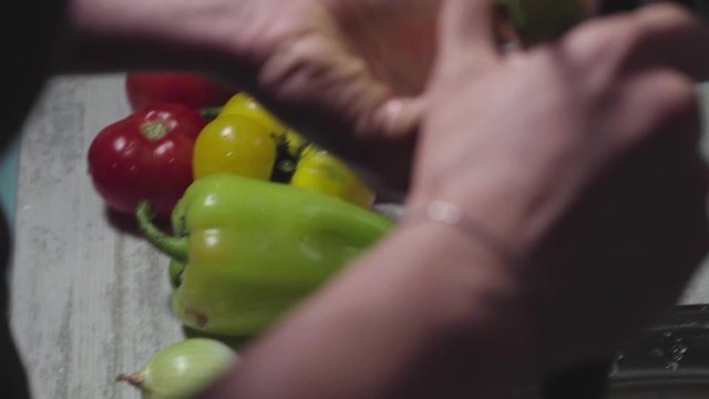 Women's hands wash, peel and cut vegetables into vegetable stew.
