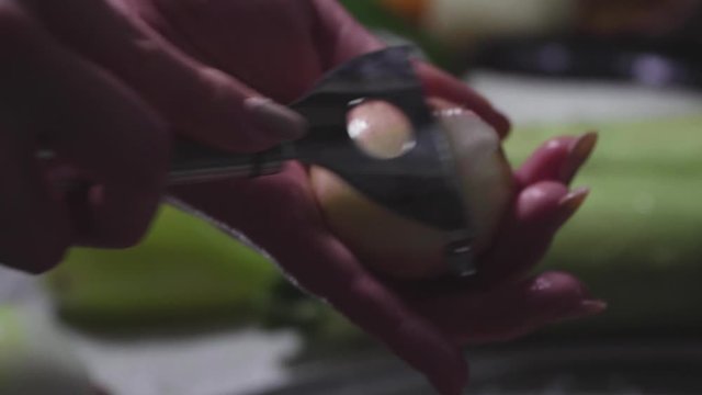 Women's hands wash, peel and cut vegetables into vegetable stew.