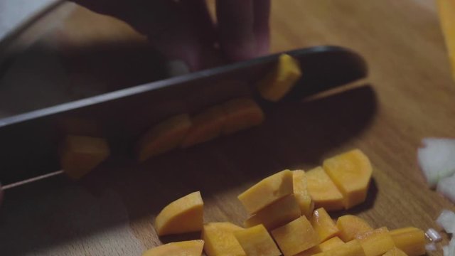 Women's hands wash, peel and cut vegetables into vegetable stew.