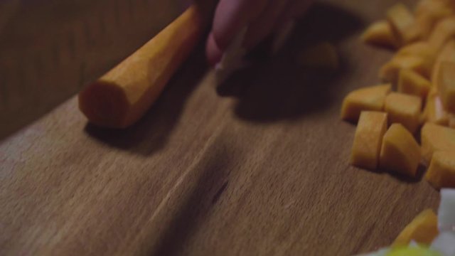 Women's hands wash, peel and cut vegetables into vegetable stew.