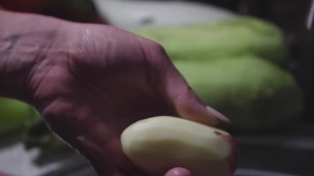 Women's hands wash, peel and cut vegetables into vegetable stew.