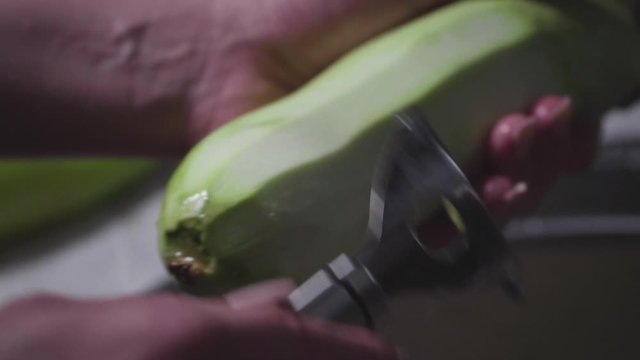 Women's hands wash, peel and cut vegetables into vegetable stew.