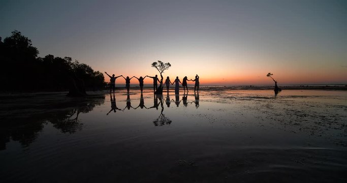 Groups of friends playing and having fun in the beach at sunset, Walakiri beach, Sumba, Indonesia