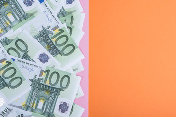 Euro cash on a pink and orange background. Euro Money Banknotes. Euro Money. Euro bill. Place for text.