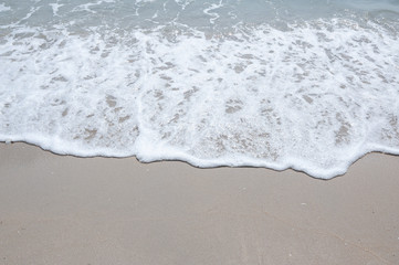 Holiday with Soft wave,Soft wave with foam of ocean on the sandy beach,Sea wave,Soft wave bubble