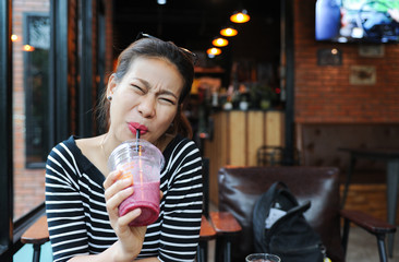 A Girl have a hypersensitive teeth wile she drink some juice,Asian Girl have a hypersensitive teeth...