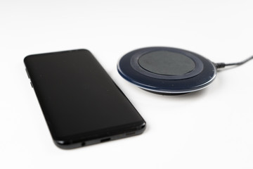 smartphone wireless charging on induction charger. Wireless charger