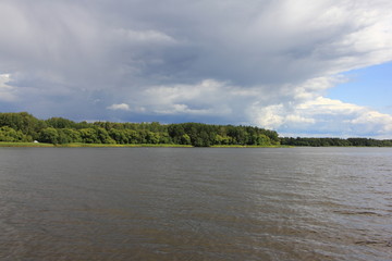 Storm clouds over the water, beautiful river landscape on a summer day