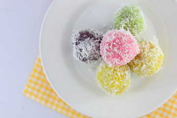 Colorful of Thai coconut  mixer or Ka Nom Tom (Thai Traditional Dessert) on white disc.