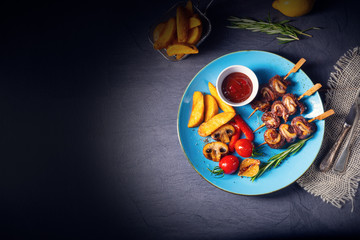 cattle shashlik skewers with grilled vegetables on a caucasian