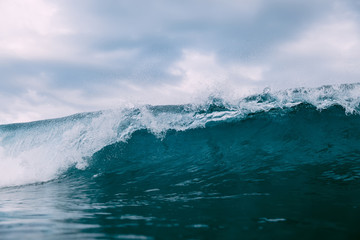 Breaking blue wave. Barrel wave for surfing.