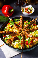 Lamb skewers with curry rice and different vegetables