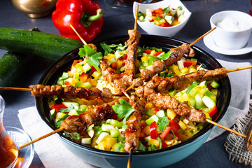 Lamb skewers with curry rice and different vegetables