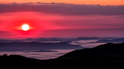 Mountains' silhouettes and pink sky. Awesome sunrise in Bieszczady Mountains. Poland