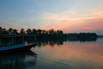 Beautiful sunset on the rever with boat in Thailand