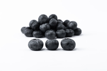 Big, sweet black blueberries on a white background