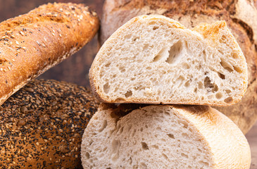 Loaf of baguette and multigrain bread close up