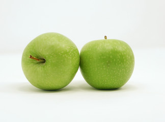 A pair of juicy, fresh green apples isolated on a white background